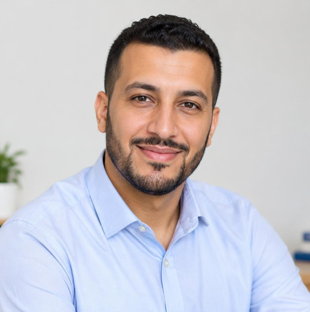 Smiling man trainer in his thirties with short dark hair and a light shirt